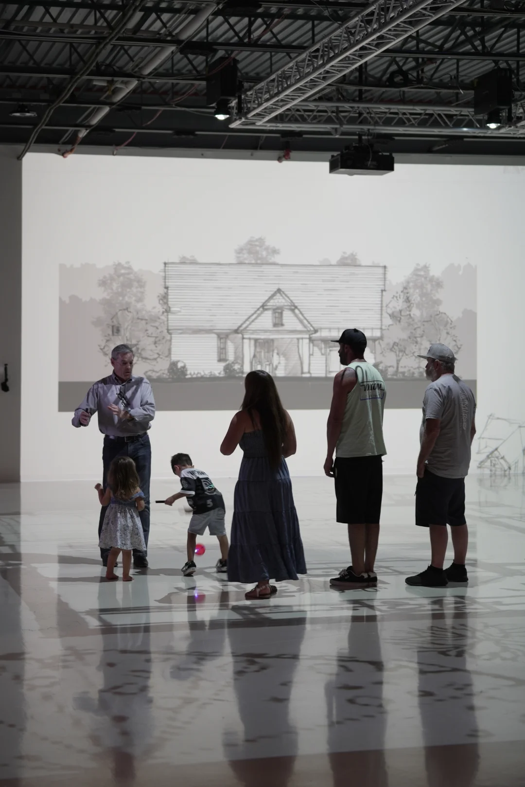 Family and builder reviewing a projected house elevation before construction