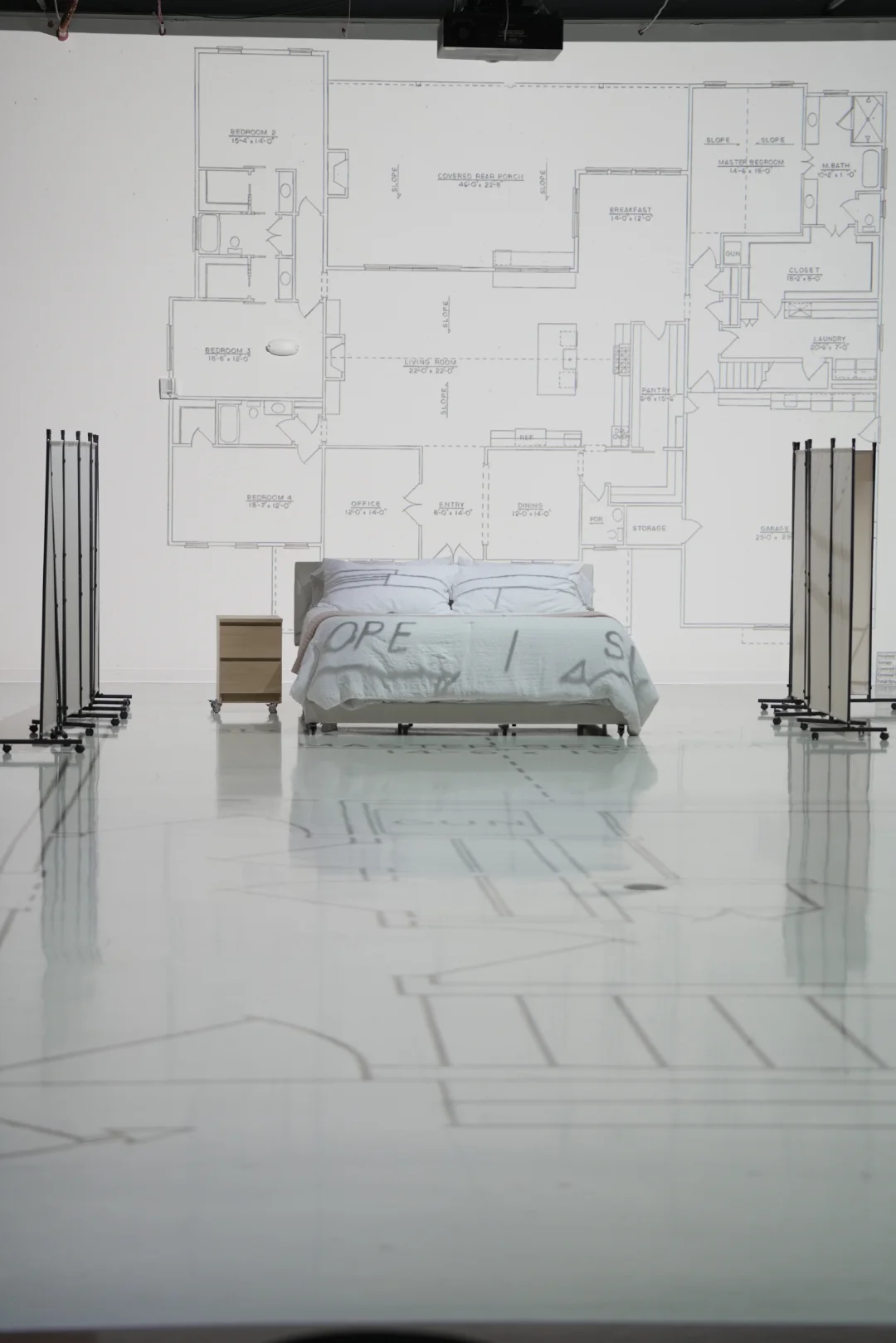 Bedroom furniture staged inside a full-scale floor plan to show true room size