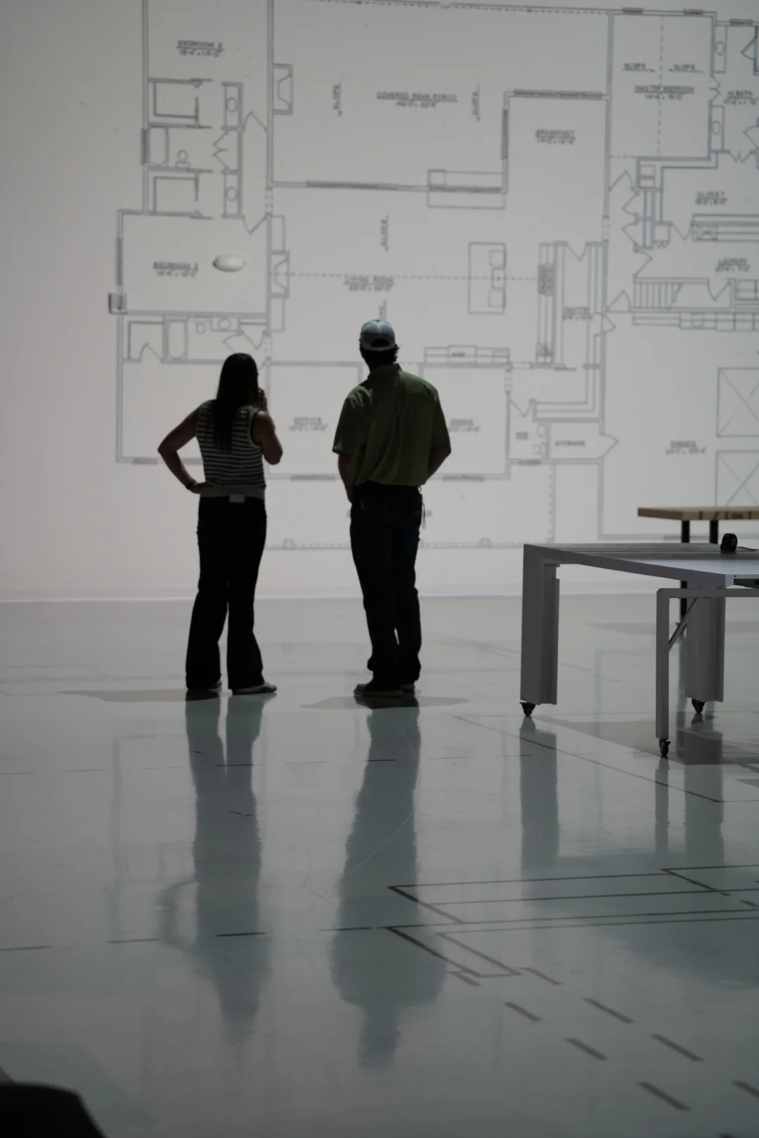 Couple reviewing their house plans on the projection wall before building