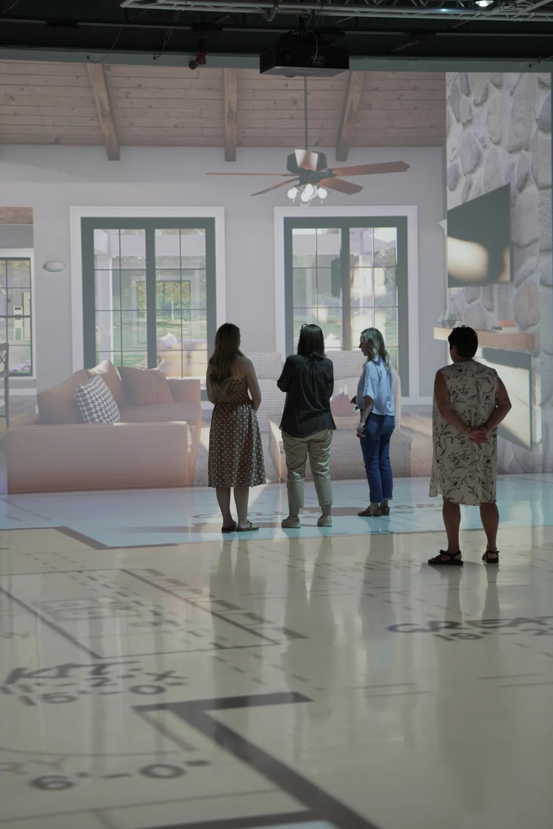 Clients viewing a full-scale 3D rendering of a living room projected in the studio. 